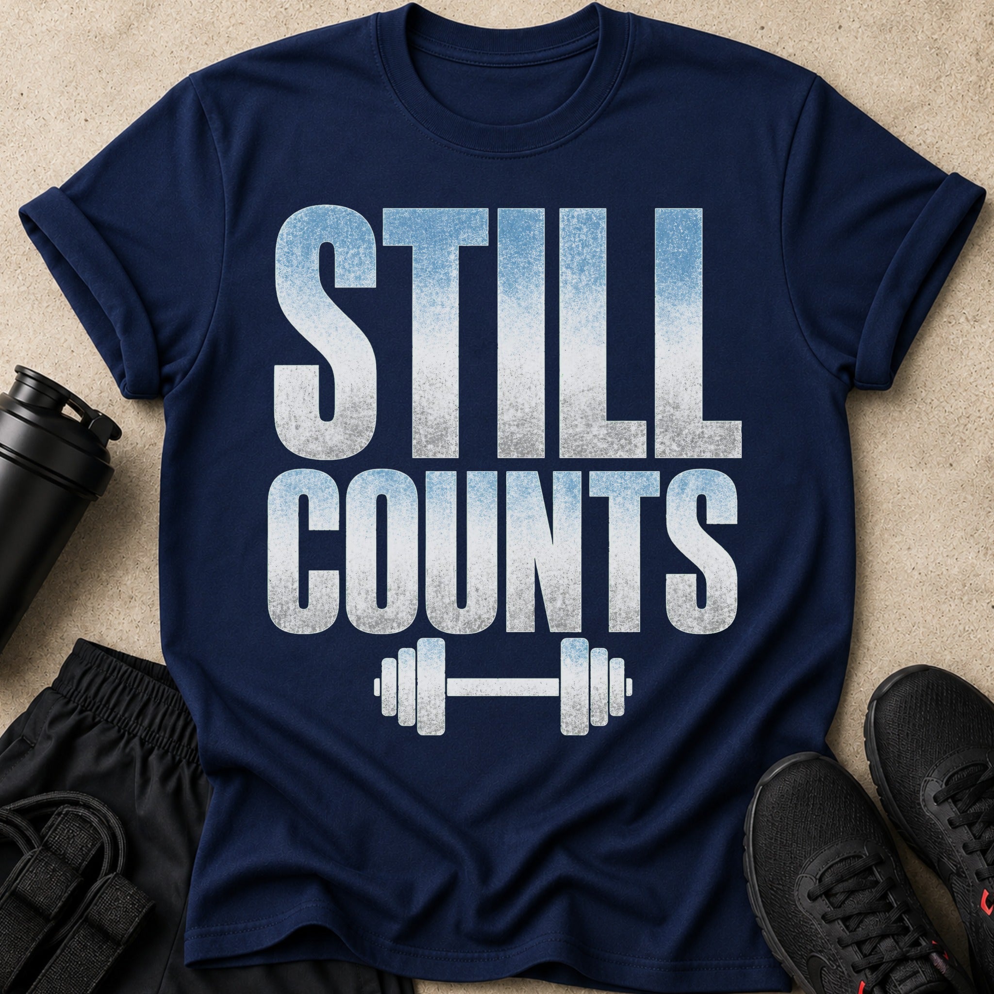 Navy t-shirt with "STILL COUNTS" text and barbell graphic.