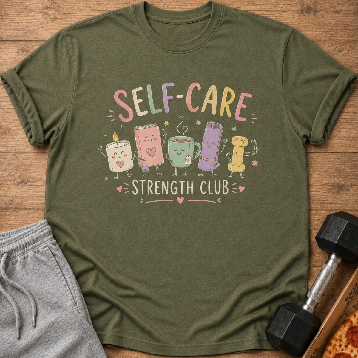 Green t-shirt with "Self-Care Strength Club" text and cartoon characters.