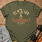 Olive green t-shirt with "Certified Participant Club" text, kettlebell graphic, and quote.