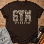 Brown t-shirt with "GYM WEATHER" text in leopard print and beige font.