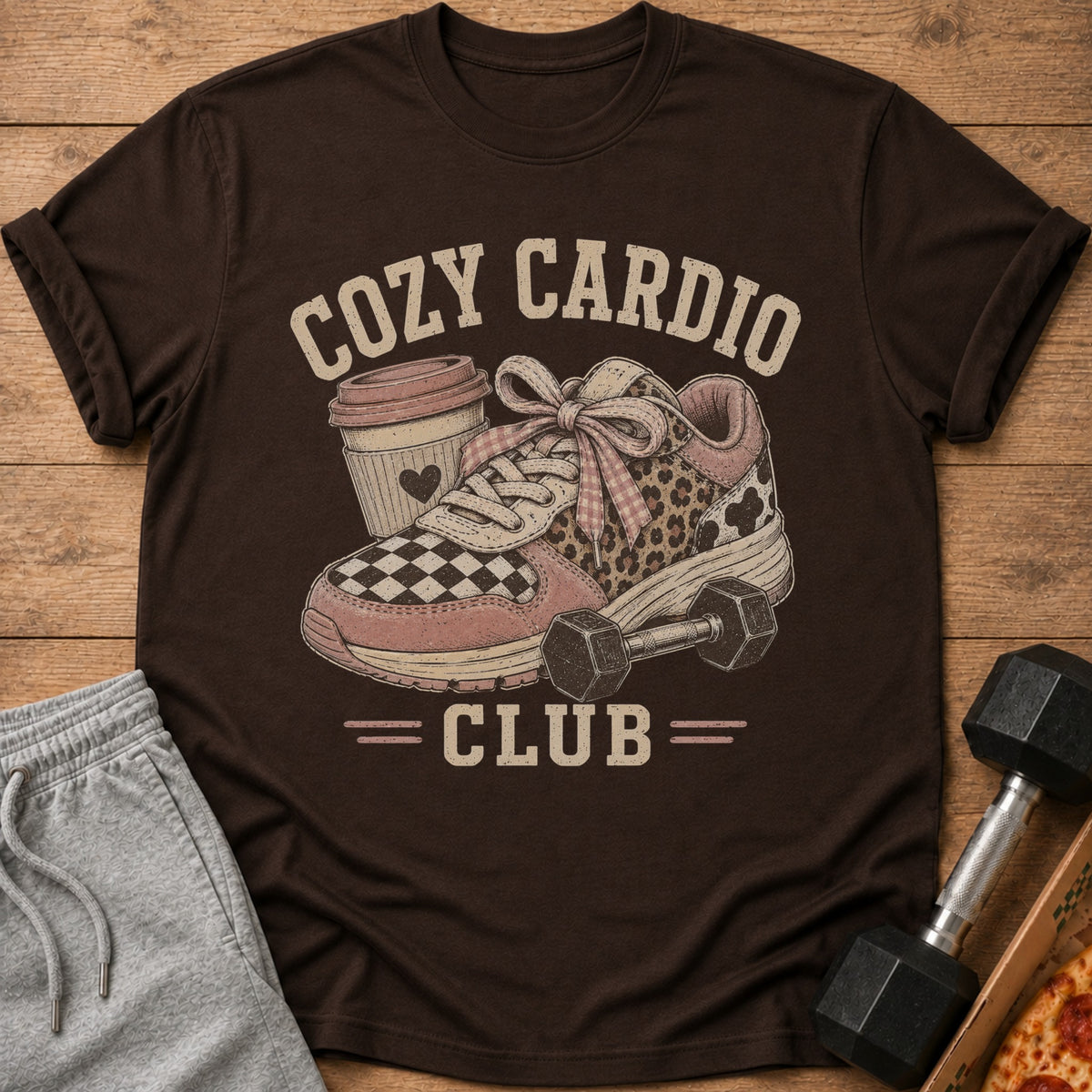 T-shirt graphic: "Cozy Cardio Club" with a sneaker, coffee cup, and dumbbell.