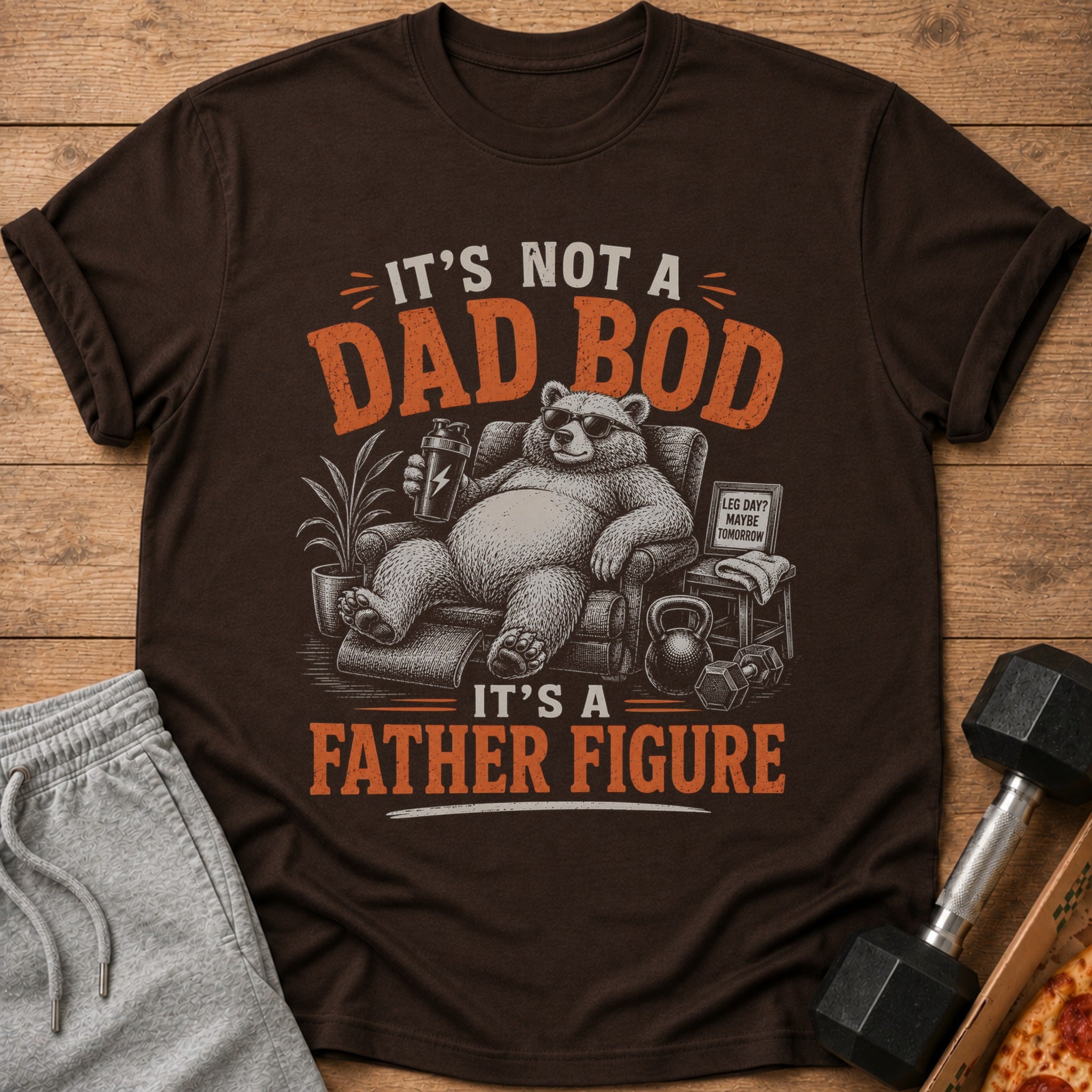 Brown t-shirt graphic: bear in chair, "It's Not A Dad Bod, It's A Father Figure."