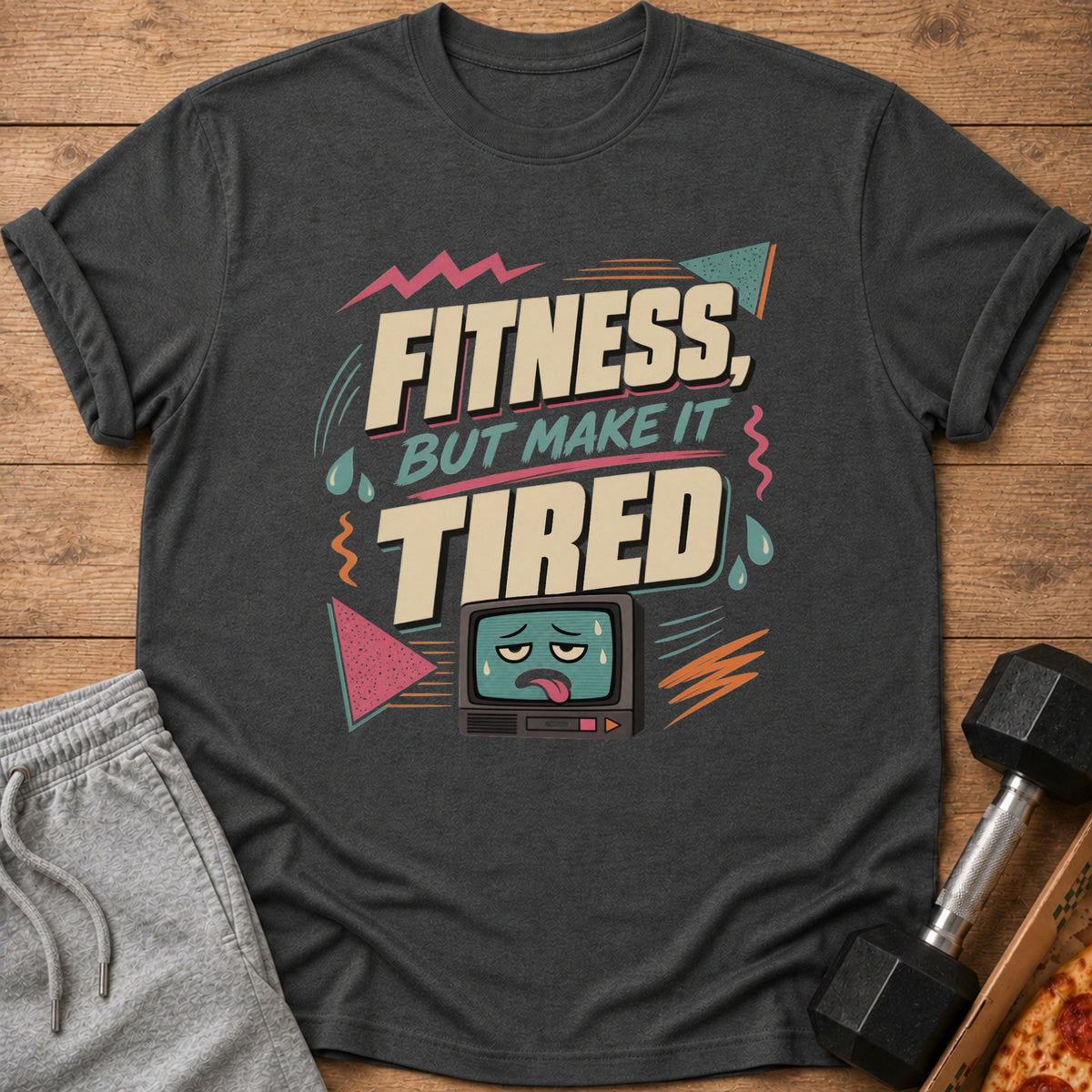T-shirt with "Fitness, But Make It Tired" text and a tired cartoon TV.