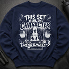 Navy sweatshirt with graphic "THIS SET BUILDS CHARACTER UNFORTUNATELY" and gym illustration.