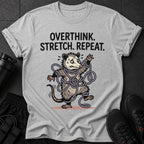 Grey t-shirt with "OVERTHINK. STRETCH. REPEAT." and tangled possum graphic.