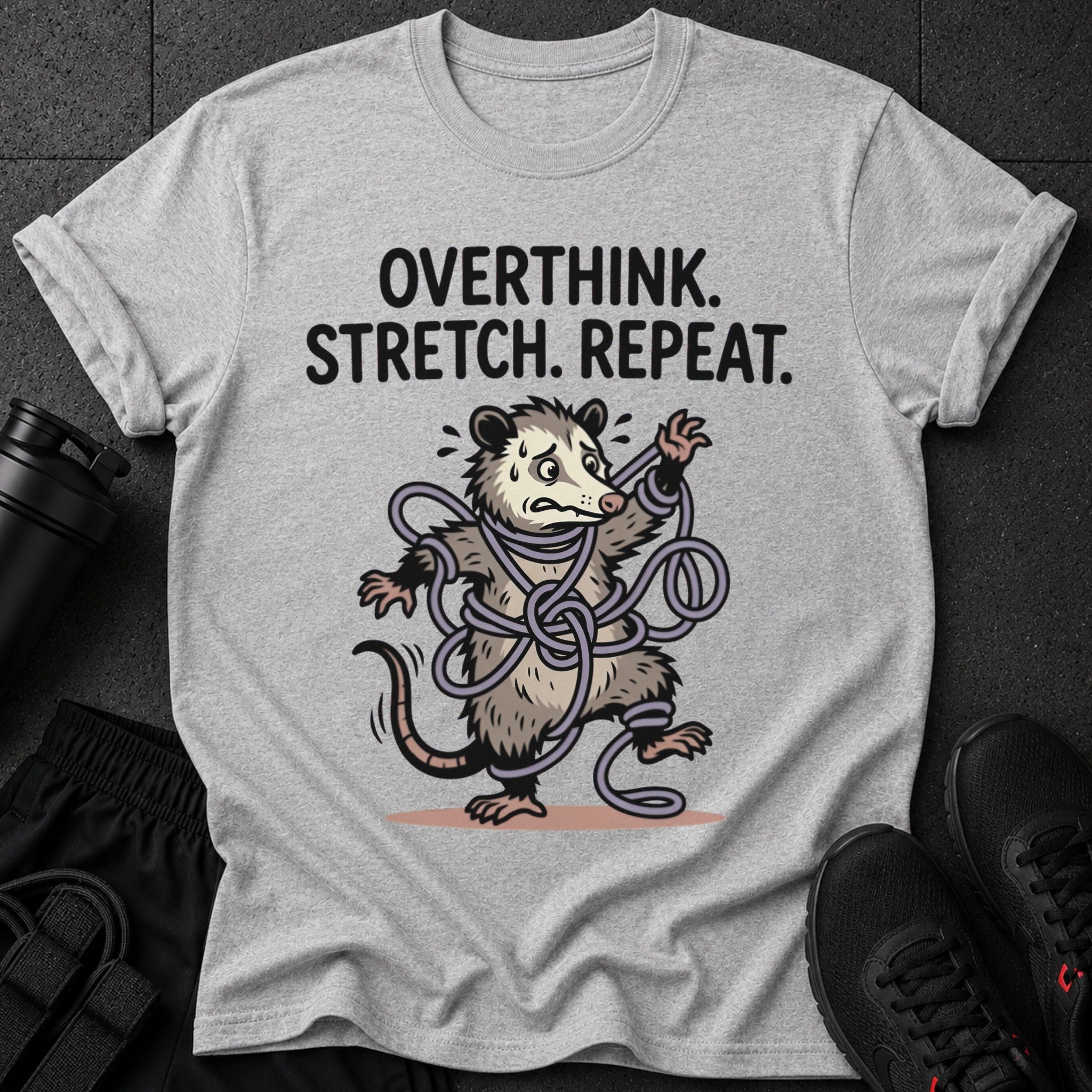 Grey t-shirt with "OVERTHINK. STRETCH. REPEAT." and tangled possum graphic.
