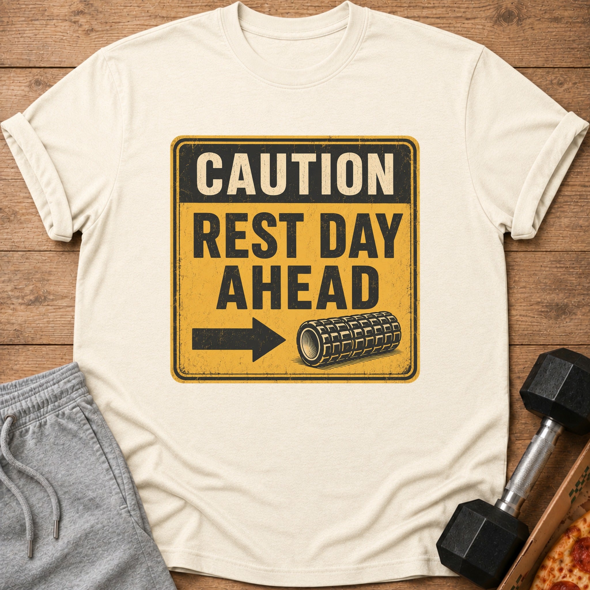Cream t-shirt with "CAUTION REST DAY AHEAD" text and a foam roller graphic.