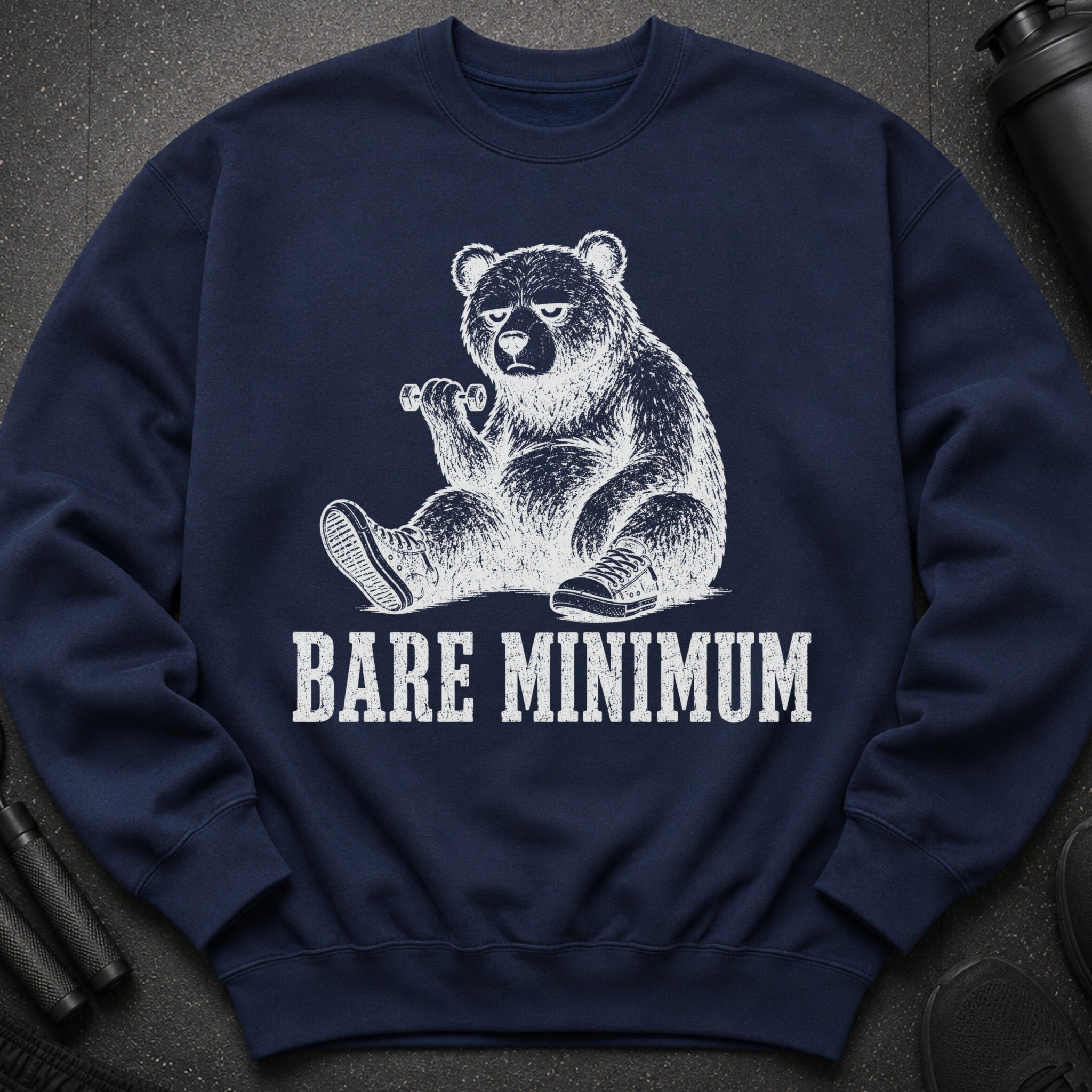 Navy sweatshirt featuring a distressed graphic of a bear holding a dumbbell, with text "BARE MINIMUM".