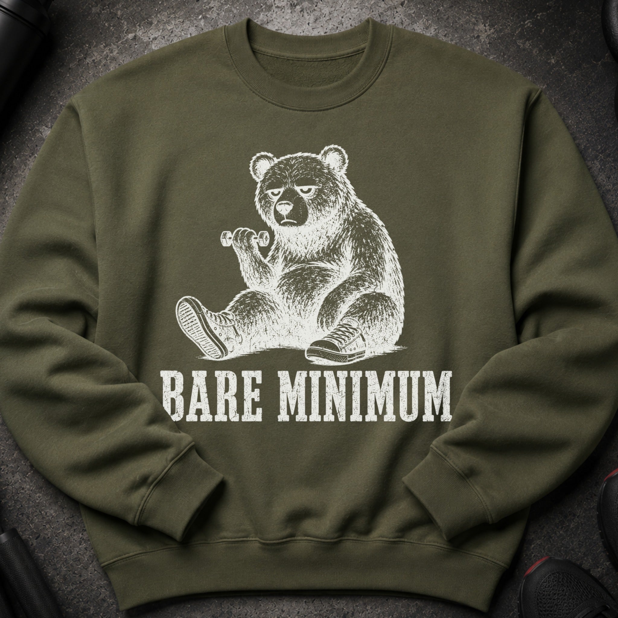 Olive sweatshirt with a distressed white graphic of a bear lifting a dumbbell, text reads "BARE MINIMUM".
