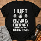 Black t-shirt with "I lift weights because therapy has opening hours" text and kettlebell graphic.
