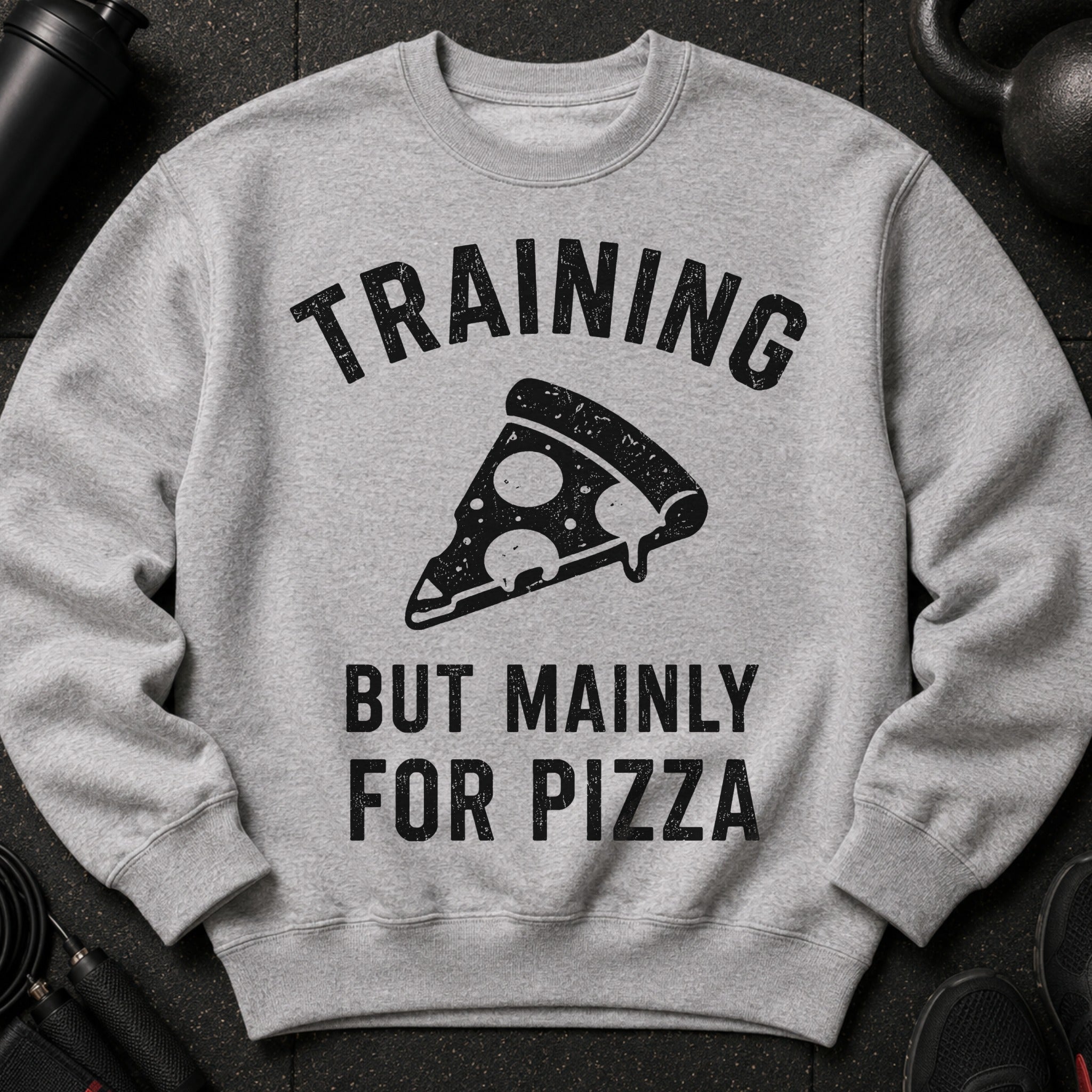 Grey sweatshirt with "TRAINING BUT MAINLY FOR PIZZA" text and pizza slice graphic.