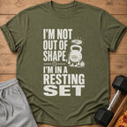 Olive green t-shirt with text "I'M NOT OUT OF SHAPE, I'M IN A RESTING SET".