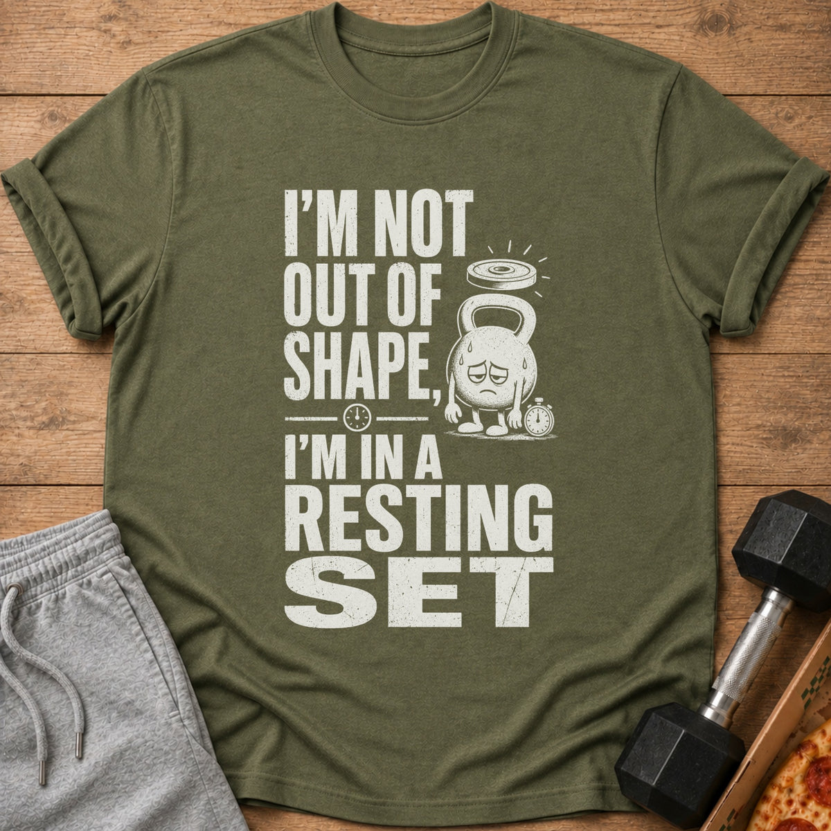 Olive green t-shirt with text "I'M NOT OUT OF SHAPE, I'M IN A RESTING SET".