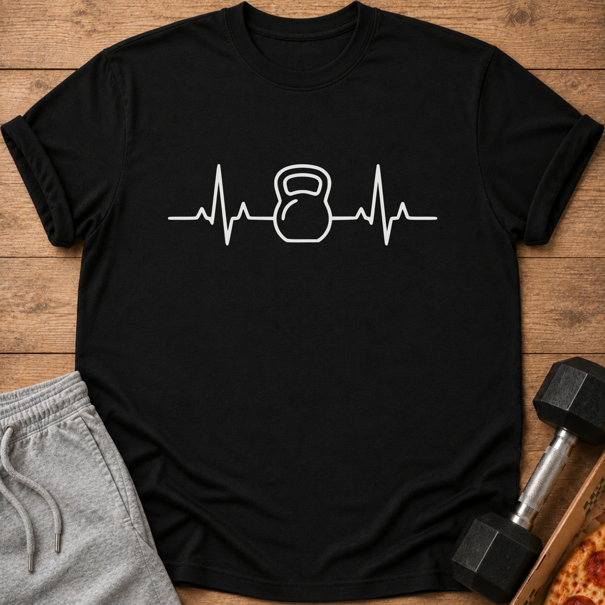 Black t-shirt with white kettlebell heartbeat graphic.
