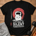 Black t-shirt with a grumpy kettlebell graphic and text "LIFTING IN SILENT DISAPPROVAL".