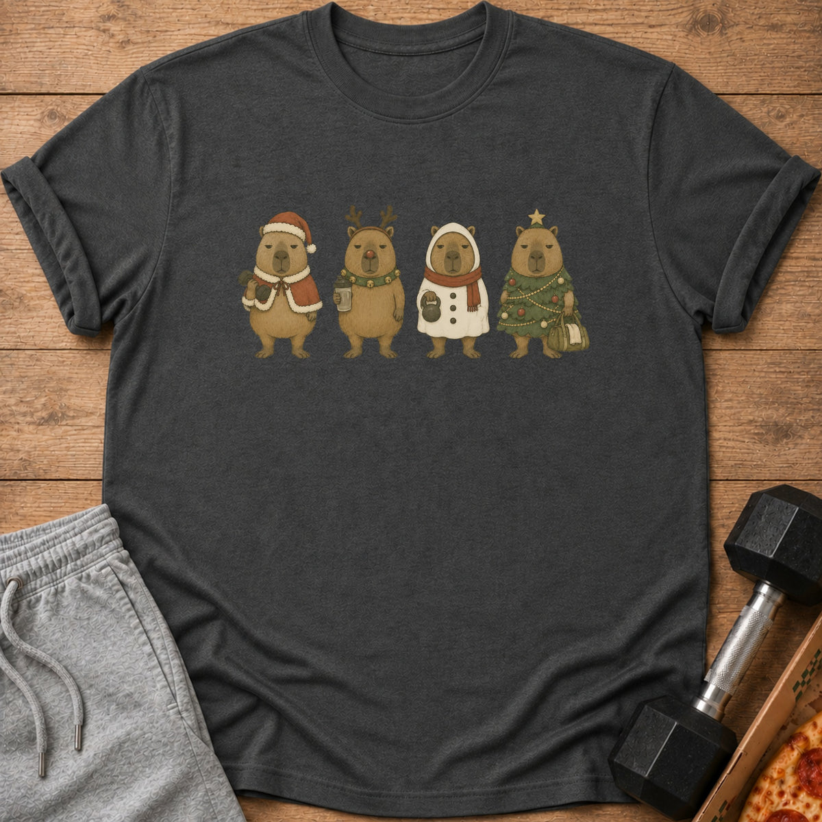 T-shirt with four capybaras in festive Christmas outfits on a wooden background.