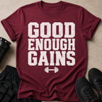Maroon t-shirt with "GOOD ENOUGH GAINS" text and barbell graphic.