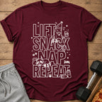 Maroon t-shirt with white text "LIFT SNACK NAP REPEAT" and graphic elements.
