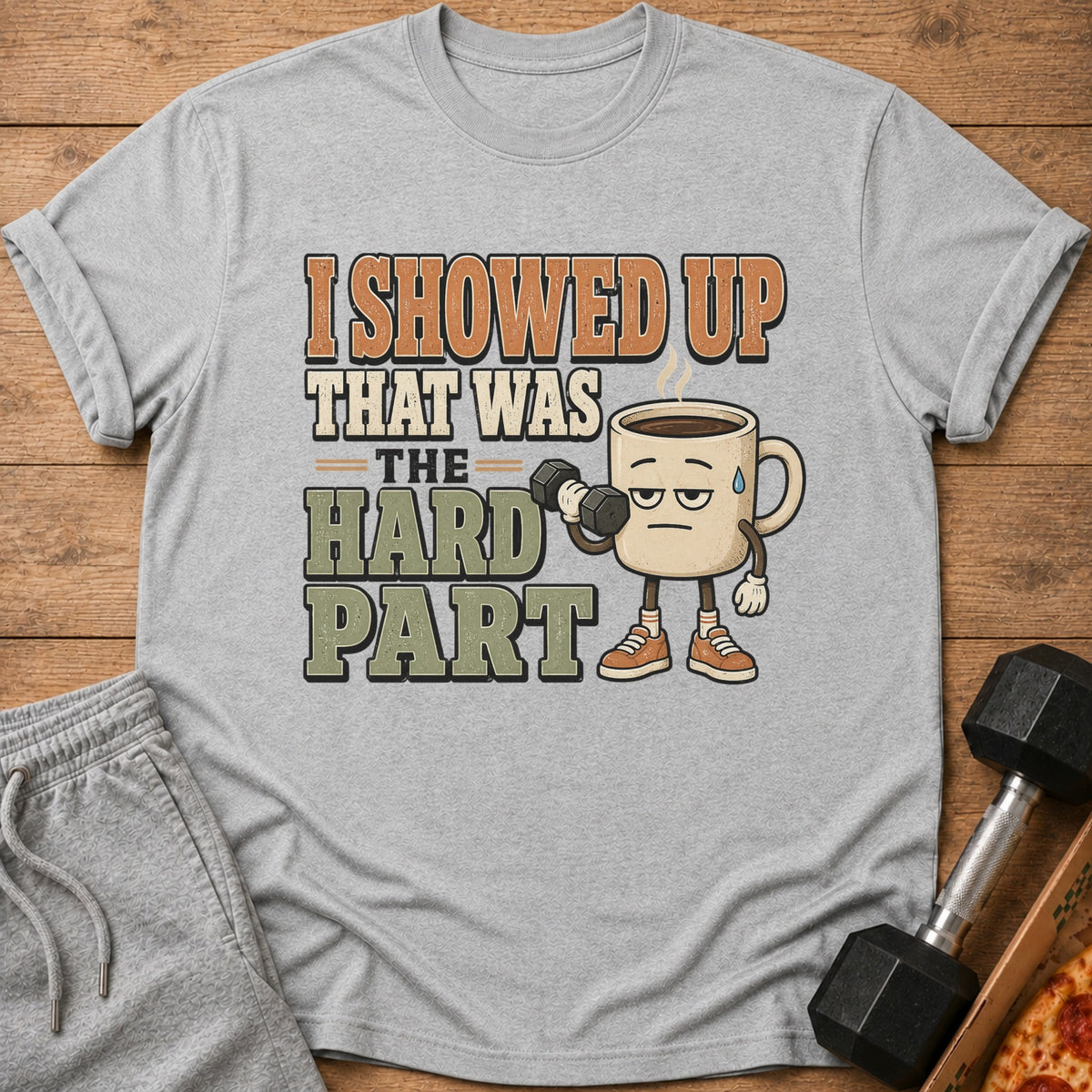 T-shirt with text "I showed up that was the hard part" and a coffee mug lifting a dumbbell.
