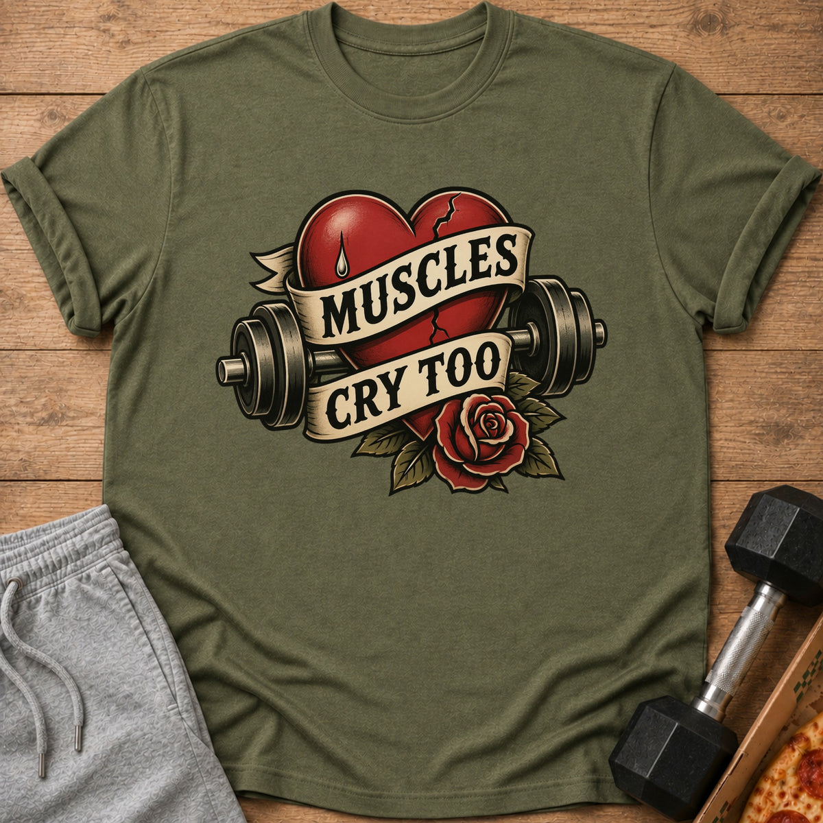 Green t-shirt with a cracked heart, dumbbells, rose, and text that reads "Muscles Cry Too."