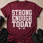 Maroon t-shirt with distressed white text reading "STRONG ENOUGH TODAY" and a barbell graphic.