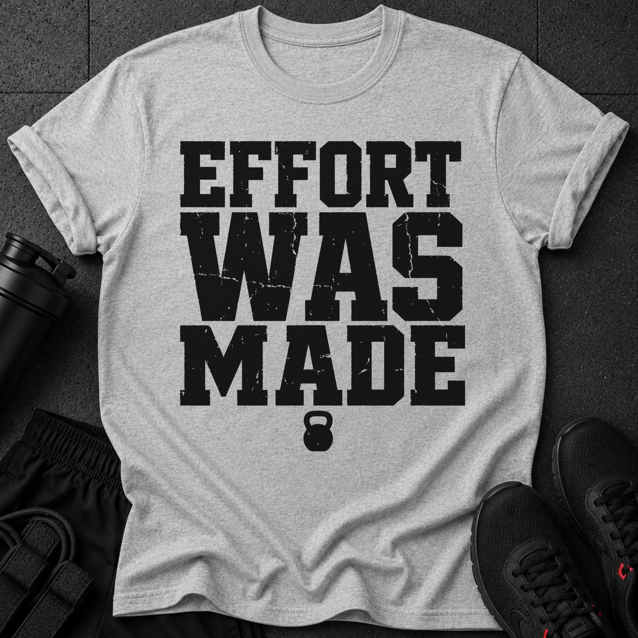 Grey t-shirt with black distressed text "EFFORT WAS MADE" and a kettlebell icon.