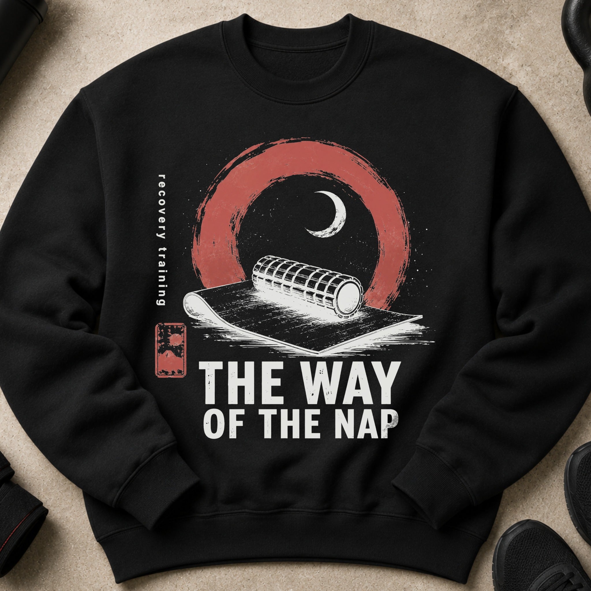 Black sweatshirt with graphic: "THE WAY OF THE NAP" and "recovery training" text, foam roller.
