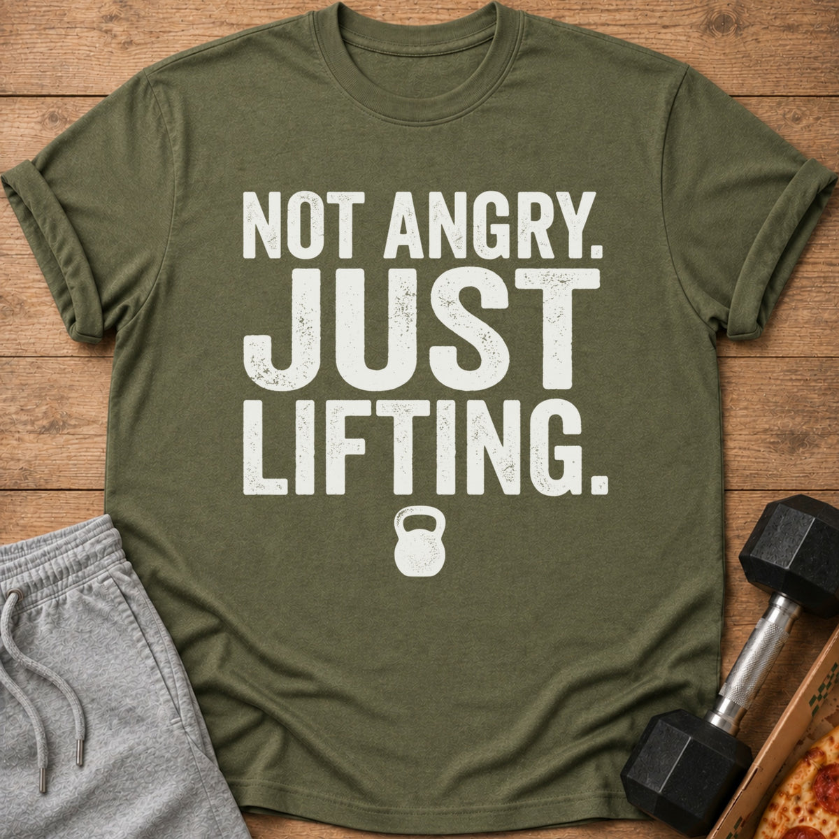 Olive t-shirt with white text "NOT ANGRY. JUST LIFTING." and a kettlebell graphic.