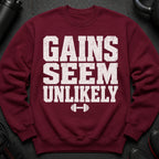 Maroon sweatshirt with white text "Gains Seem Unlikely" and a dumbbell graphic.