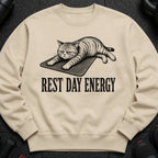 Light tan sweatshirt with graphic of a grumpy cat and text "REST DAY ENERGY".