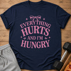 Navy t-shirt with pink text that reads "Everything Hurts and I'm Hungry."