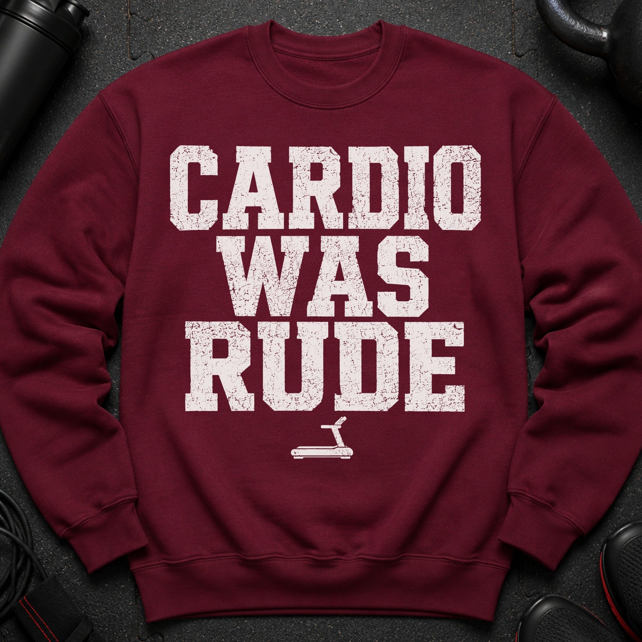 Maroon sweatshirt with white text that reads "Cardio Was Rude" and a treadmill icon.