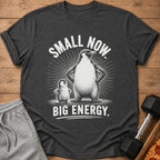 T-shirt with two penguins, large and small, and text "SMALL NOW. BIG ENERGY."