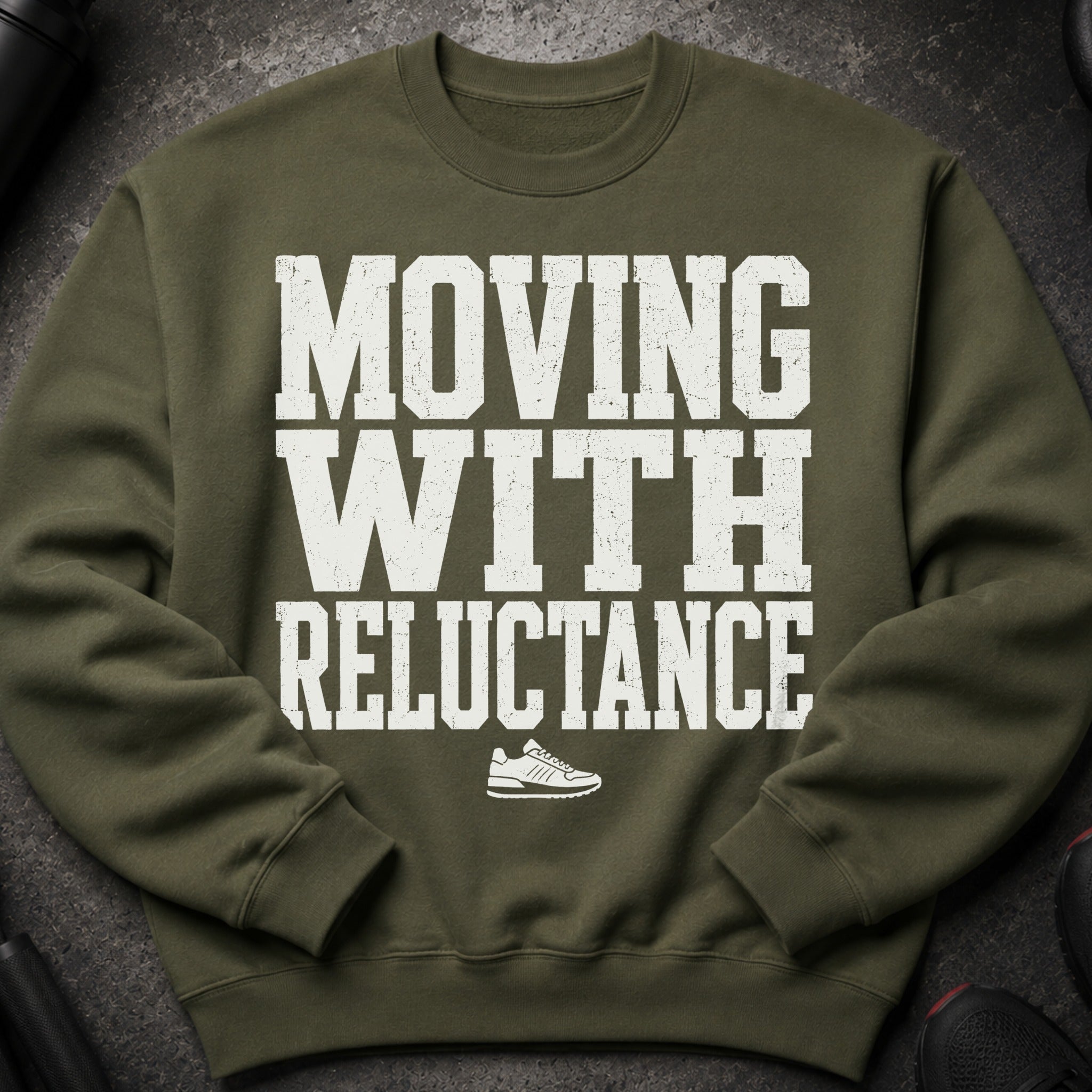 Olive green sweatshirt with white text "MOVING WITH RELUCTANCE" and a sneaker graphic.