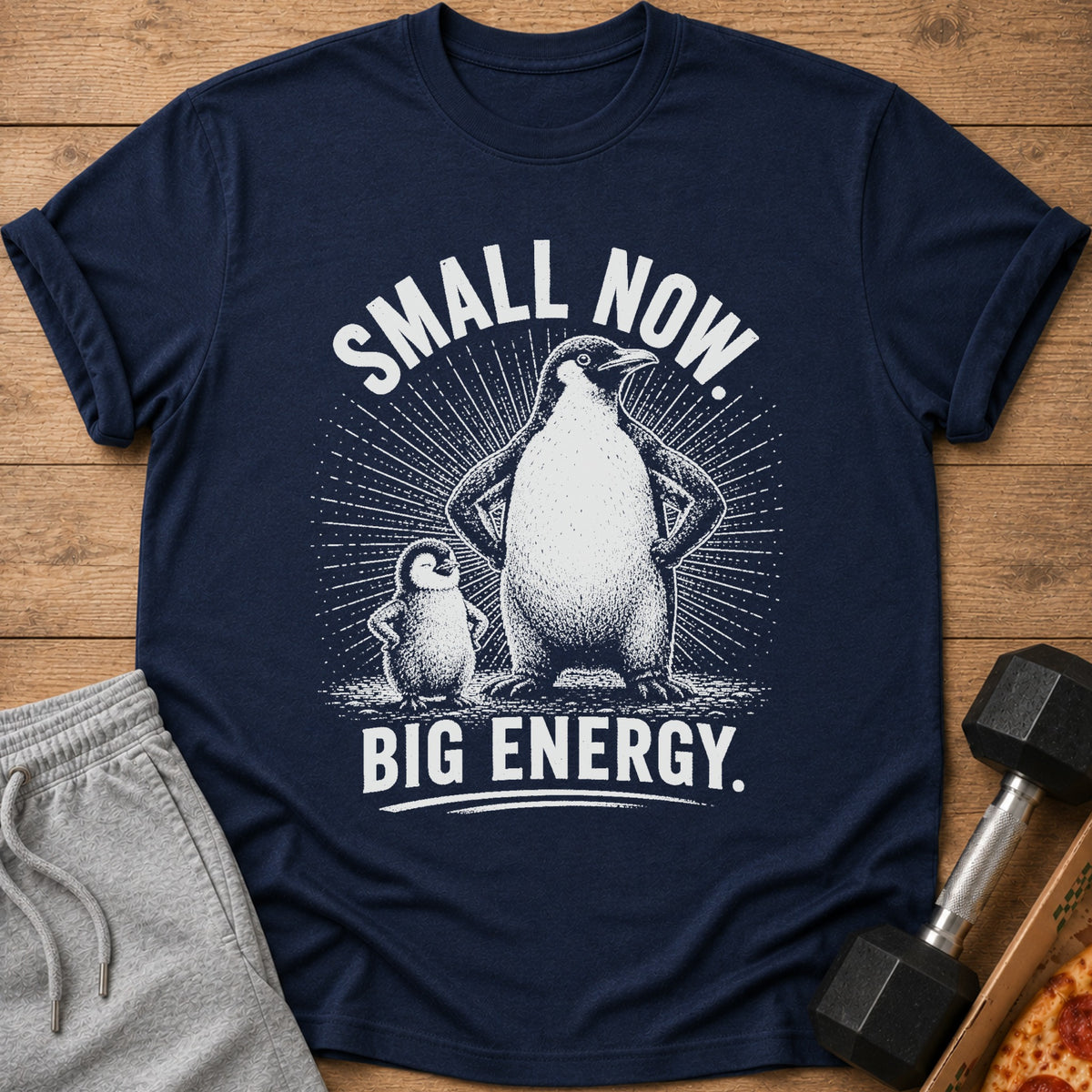Navy t-shirt with white graphic of adult and baby penguins; "Small Now. Big Energy."
