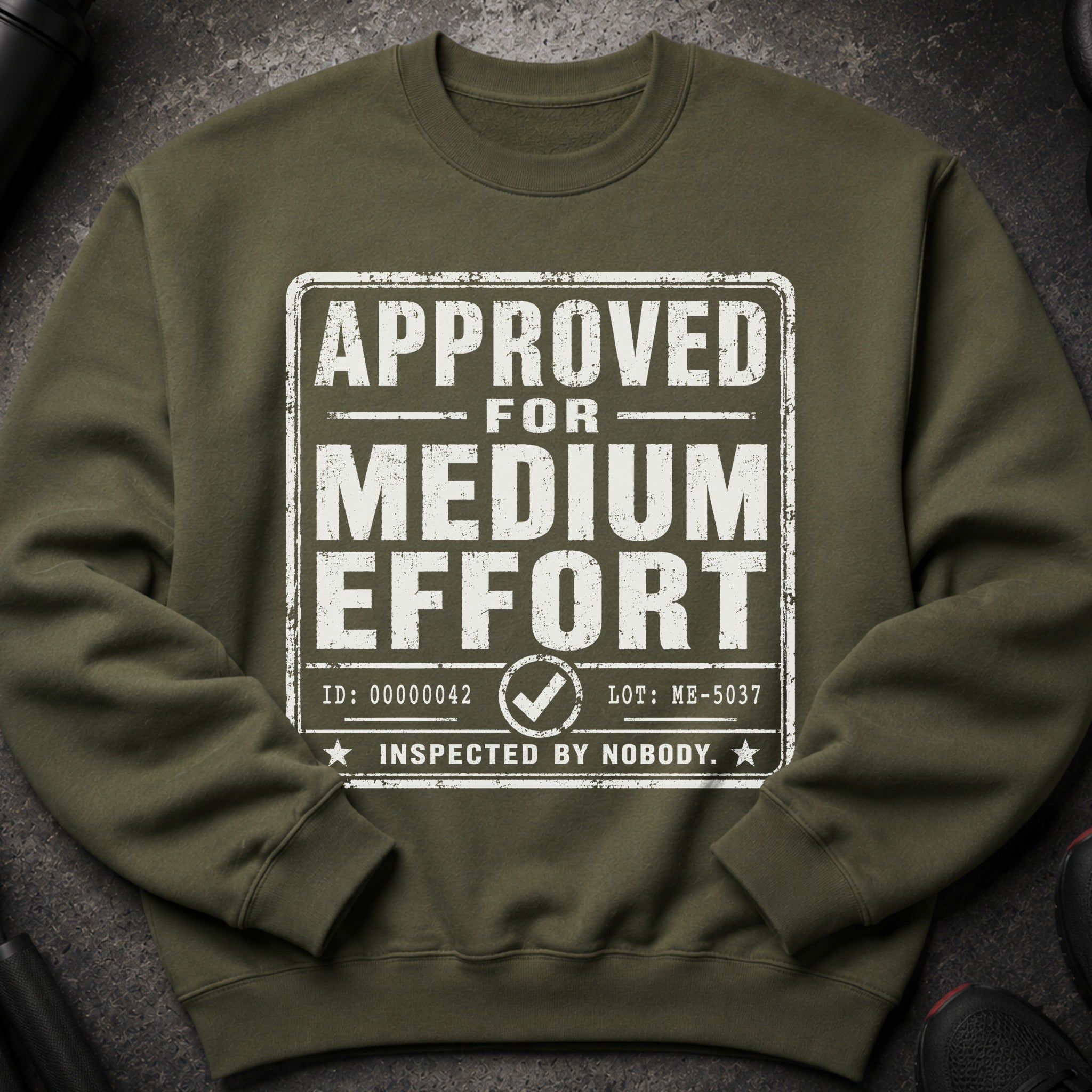 Olive green sweatshirt with "APPROVED FOR MEDIUM EFFORT INSPECTED BY NOBODY" graphic.