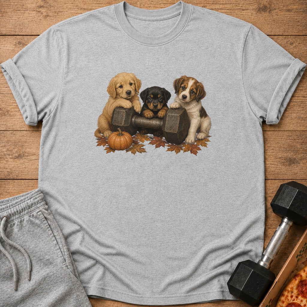 Three puppies on a dumbbell with autumn leaves and a pumpkin.