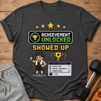 Pixel art graphic on t-shirt: "Achievement Unlocked Showed Up" with stats.
