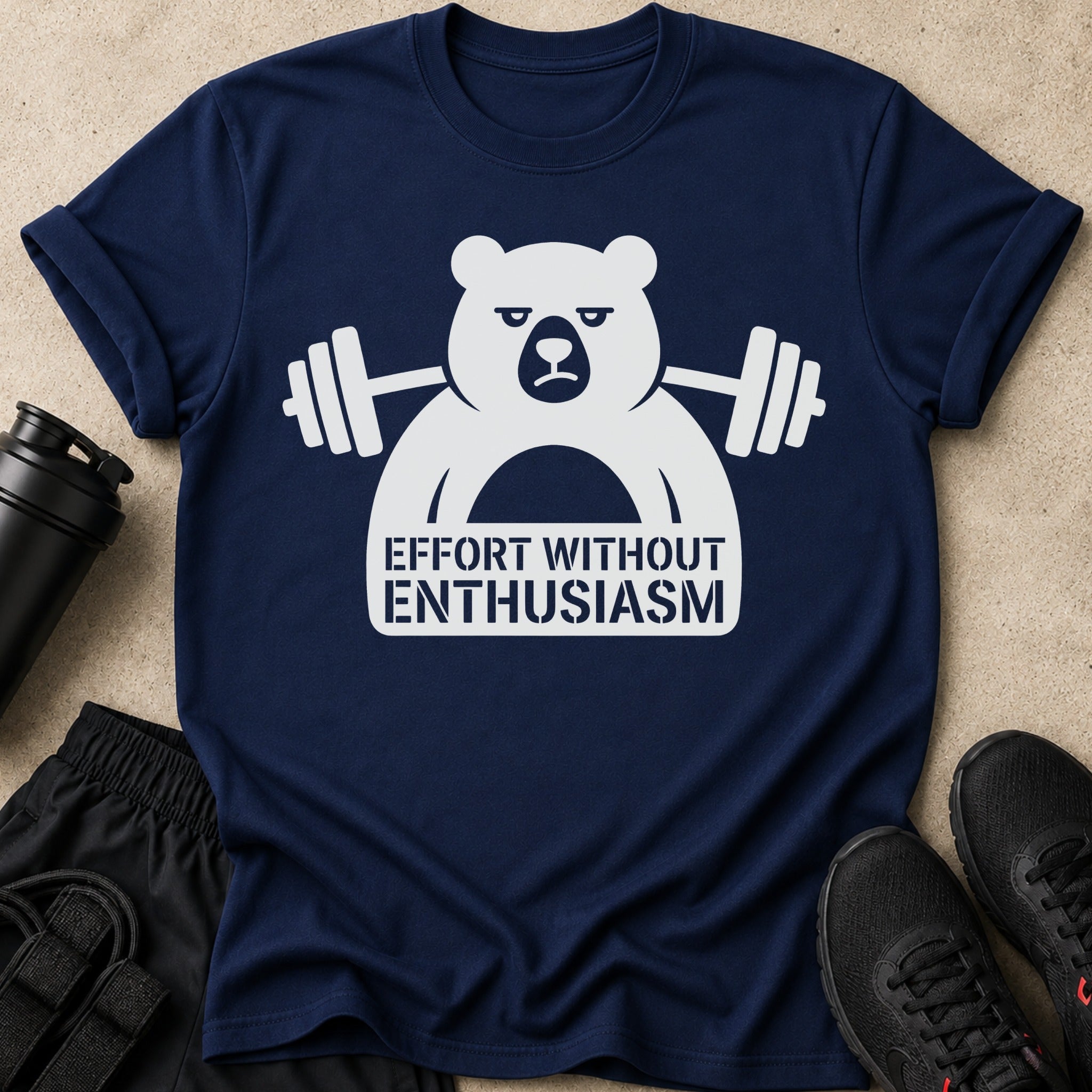 Navy t-shirt with white graphic of grumpy bear lifting weights and text "Effort Without Enthusiasm".