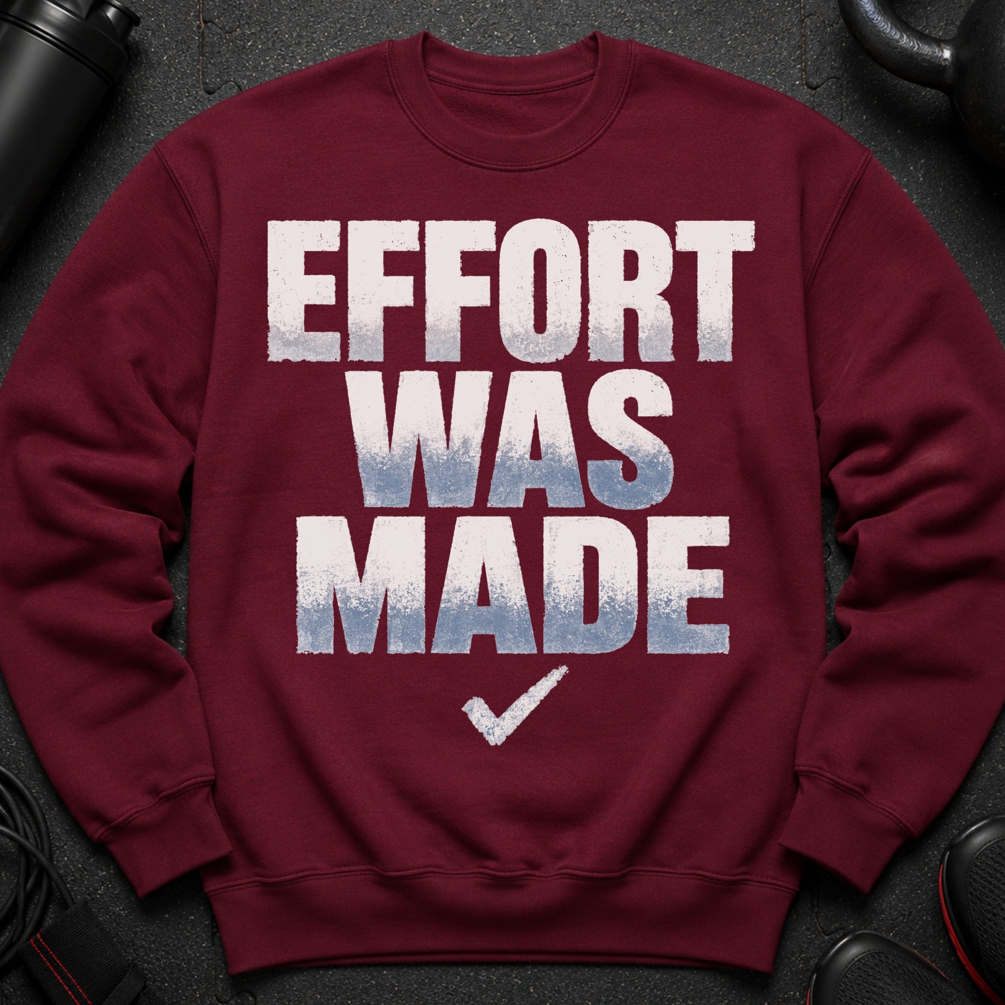 Maroon sweatshirt with white and blue text reading "EFFORT WAS MADE" and a checkmark.