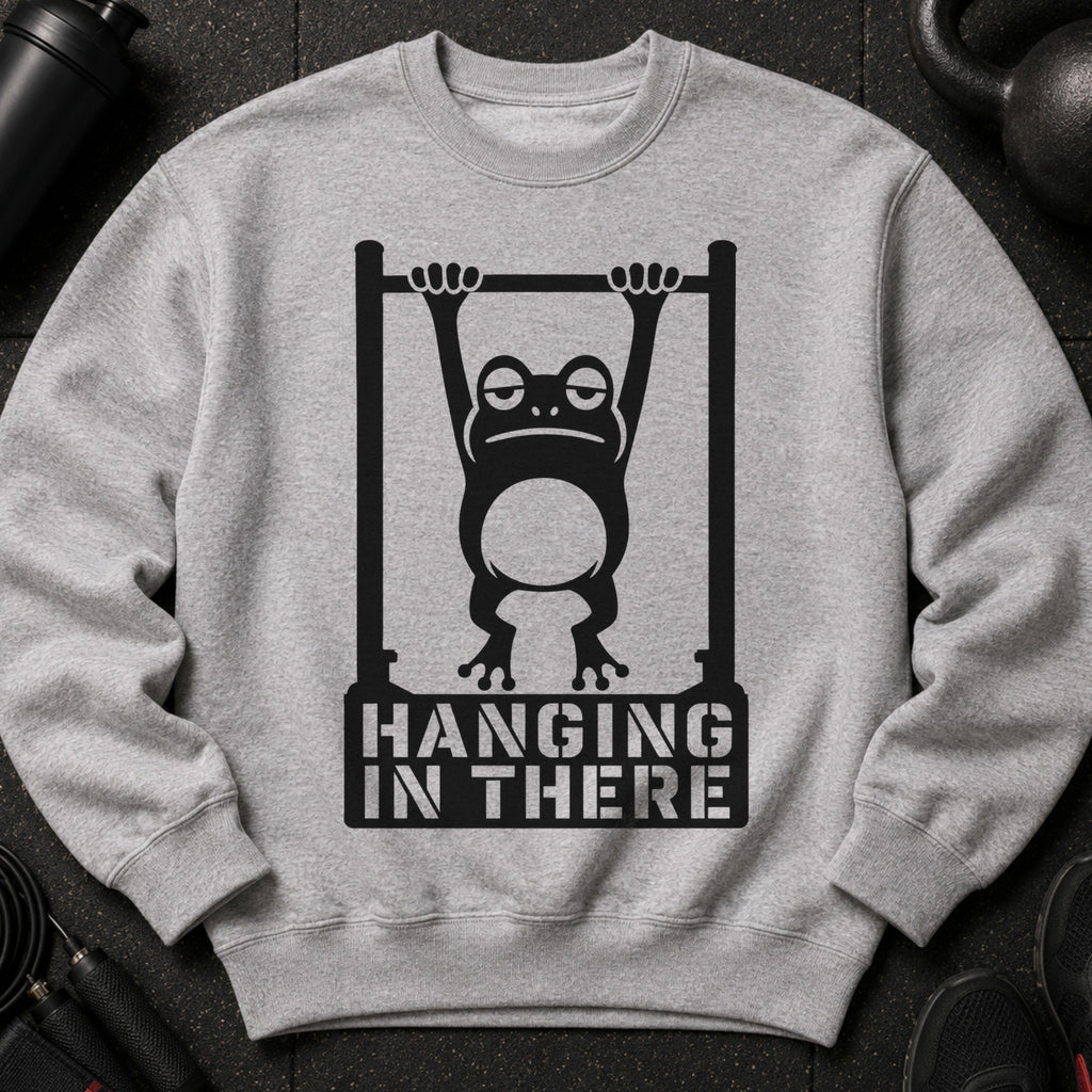 Grey sweatshirt with a graphic of a frog on a pull-up bar and text "HANGING IN THERE".
