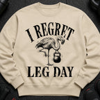 Crewneck sweatshirt with a flamingo holding a kettlebell and text reading "I regret leg day."