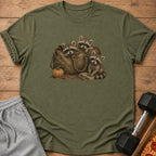 T-shirt graphic of three raccoons peeking out of a duffel bag with a pumpkin.