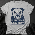 Grey t-shirt with navy bulldog graphic and text "SURVIVING LEG DAY".