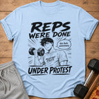 Light blue t-shirt with black graphic of anime man lifting dumbbell, text "Reps were done under protest."
