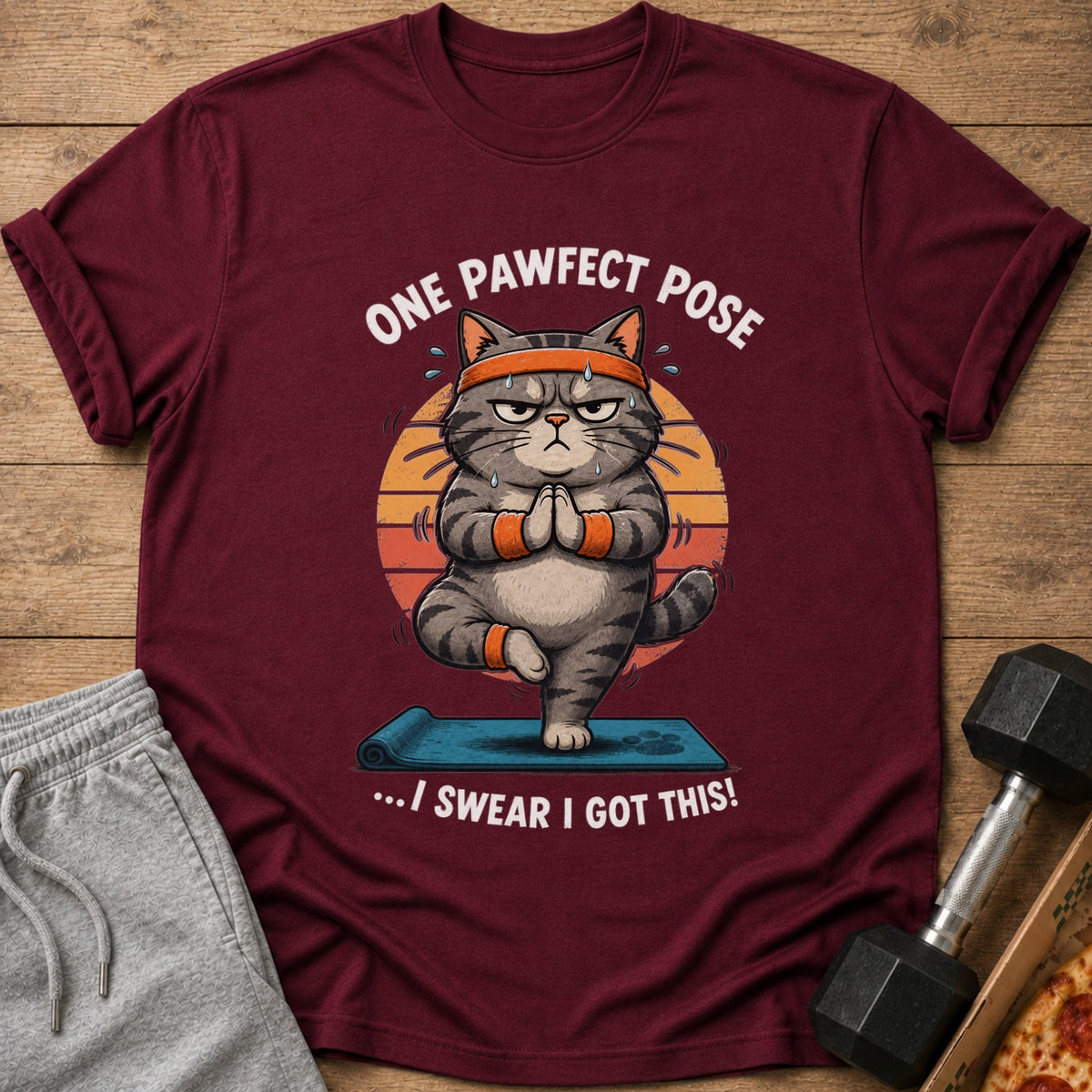 Maroon t-shirt with cartoon cat doing yoga and text "One Pawfect Pose...I Swear I Got This!"