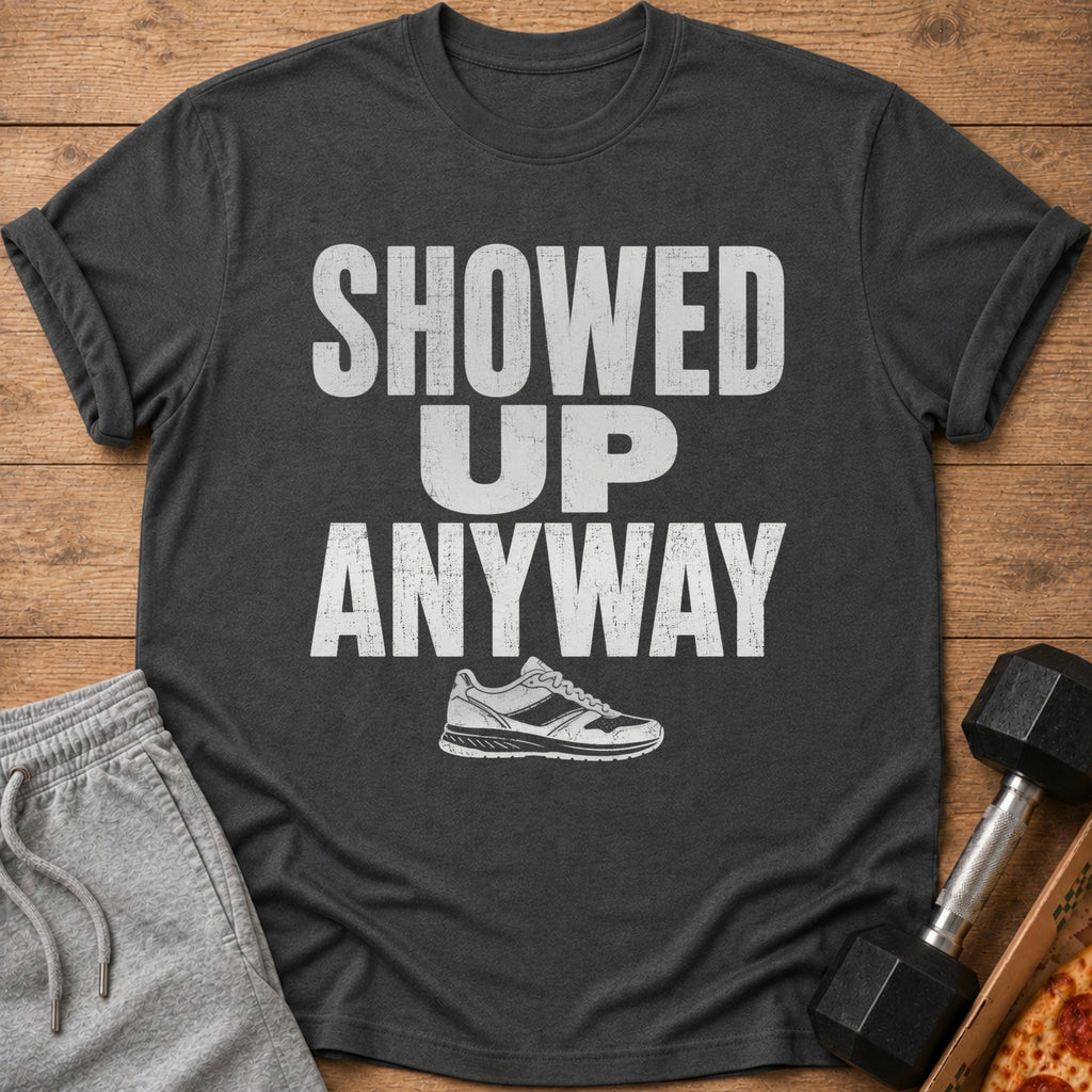 Dark gray t-shirt with white text "SHOWED UP ANYWAY" and a running shoe graphic.