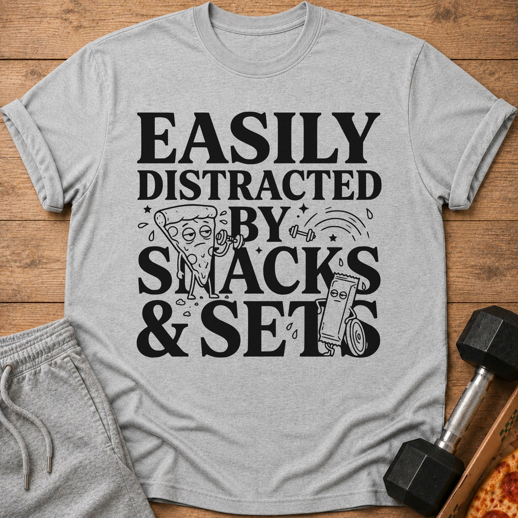 Grey t-shirt with "Easily Distracted By Snacks & Sets" graphic and cartoon workout pizza and candy bar.