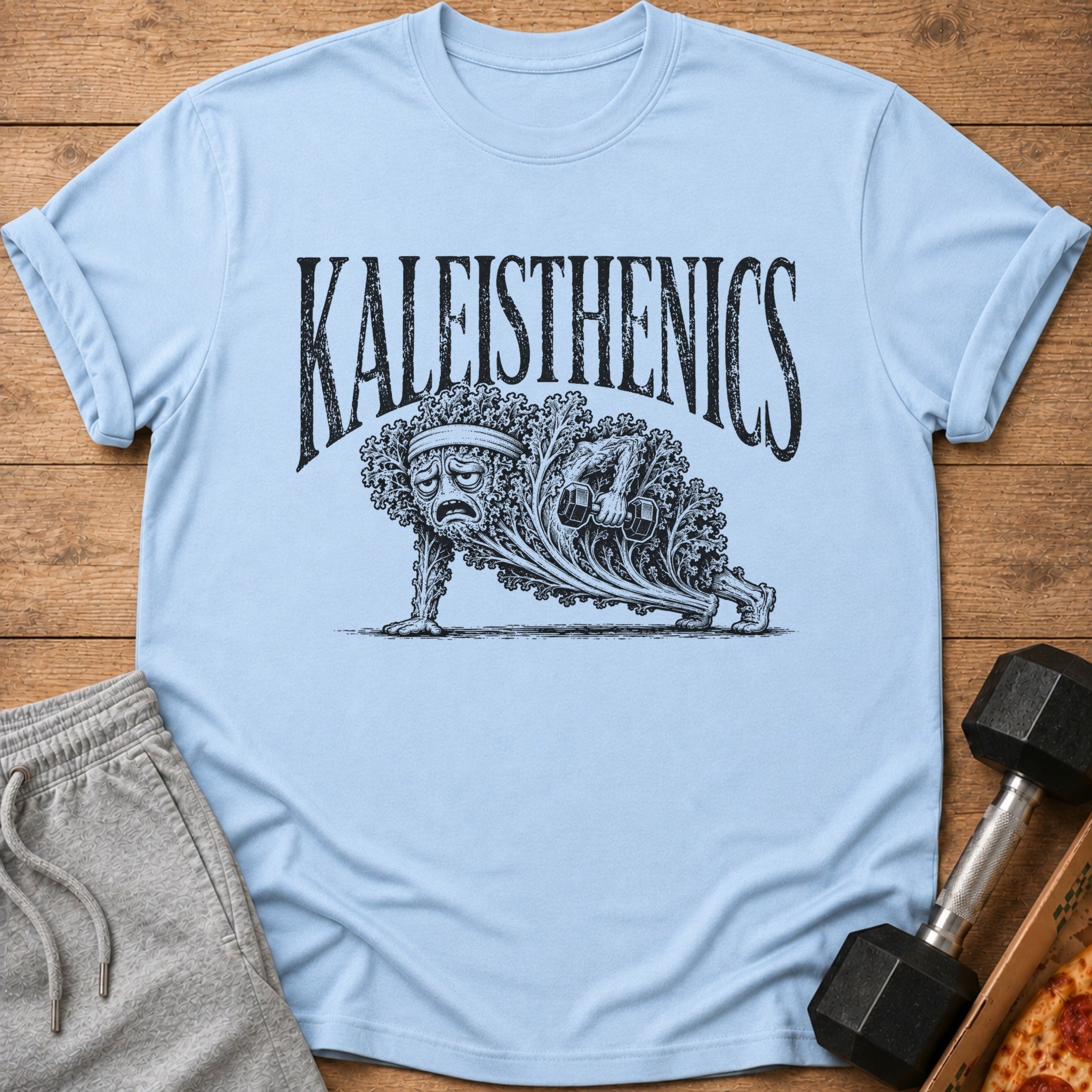 Light blue t-shirt with black "KALEISTHENICS" text and drawing of kale doing a push-up.