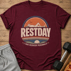 Maroon t-shirt with "RESTDAY I TAKE RECOVERY PERSONALLY" text and sun graphic.